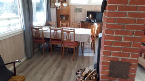a kitchen and dining room with a table and chairs at Eikheim in Birkeland