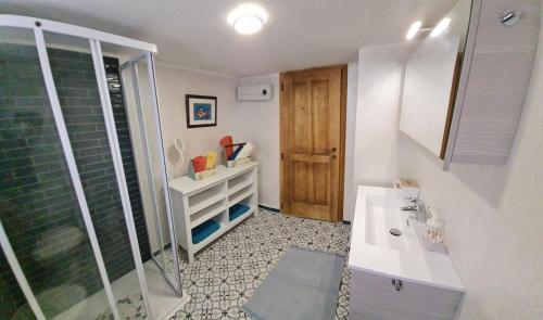 a bathroom with a shower and a white sink at Apartma Pri Lukšu in Tolmin