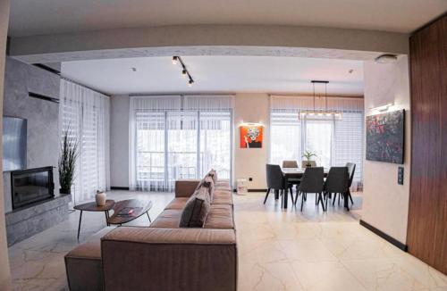 a living room with a couch and a dining room at Chalet 348 in Palyanytsya