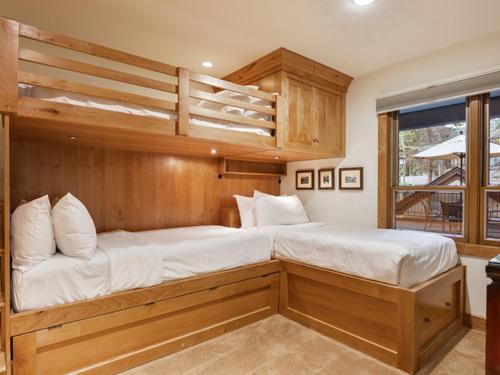 a bedroom with two bunk beds and a balcony at Montaneros in Vail in Vail