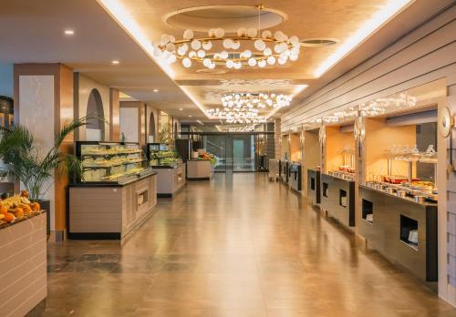 a long hallway of a restaurant with a food court at TUI Magic Life Rixos Beldibi - Adult Only in Beldibi