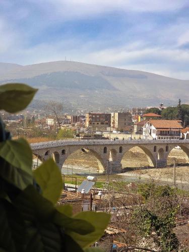 a bridge over a city with a mountain in the background at Hotel Gorica - UNESCO quarter in Berat