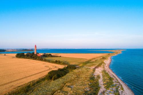 an aerial view of a lighthouse next to the water at BeltBlick 19 – Exklusive Ferienwohnung mit Garten und Meerblick in Fehmarn
