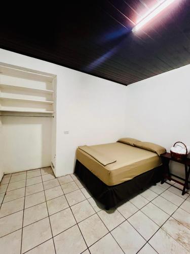 a bedroom with a bed in a white wall at Casa Imabite in León