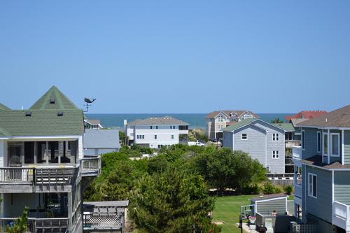 a group of houses in a small town at My Happy Place by Village Realty in Corolla