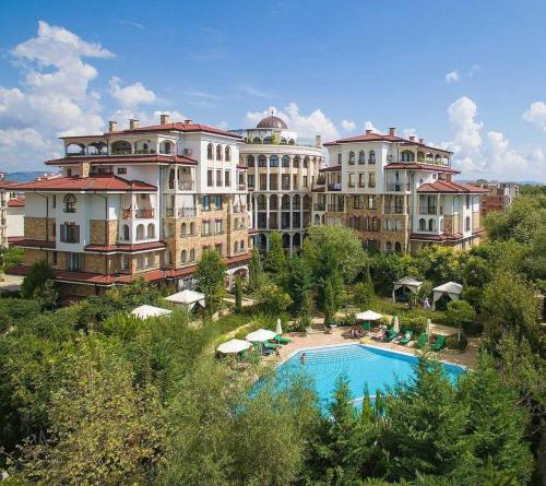 a resort with a swimming pool and some buildings at Studio Esteban in Nesebar