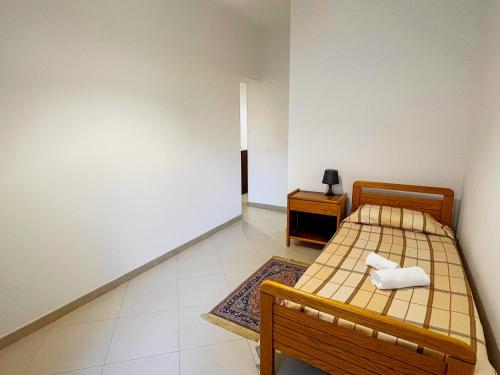 a small bedroom with a bed and a night stand at Casa Vacanza Acquanuova in Calatafimi