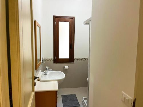 a bathroom with a sink and a mirror at Casa Vacanza Acquanuova in Calatafimi