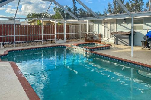 a swimming pool with blue water in a house at 1 Mi to Beach Nokomis Home with Private Pool in Nokomis