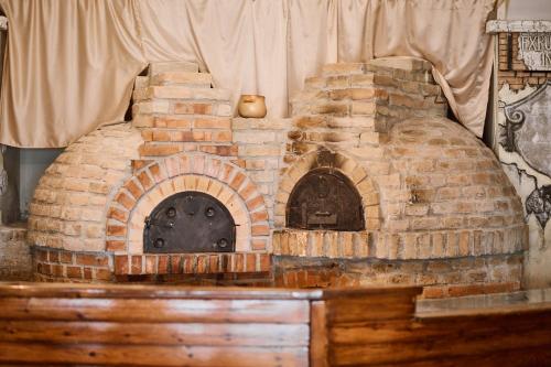 a brick oven sitting on top of a wooden table at Hotel Selce in Selce