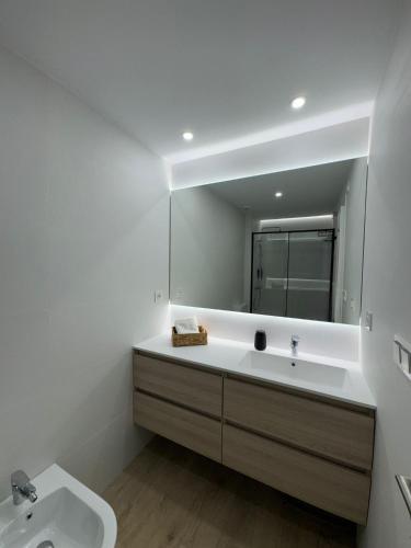 a bathroom with a sink and a mirror at Playa Granada Mar de Fabiola in Motril