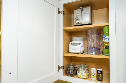 a kitchen pantry door with a cupboard filled with food at Emerald Luxe Lakeview 6 min to EPIC Universe in Orlando