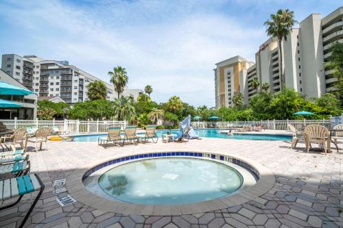 a swimming pool with chairs and a table and a patio at Emerald Luxe Lakeview 6 min to EPIC Universe in Orlando