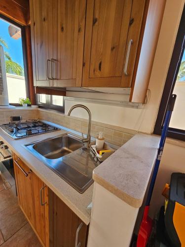 a kitchen with a sink and a stove at Villa Puglia AR 700m from beach -max 4 people- in Bisceglie