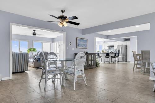 a dining room and living room with a table and chairs at Waterfront Retreat with Dock and Bay Views in Seaside Heights