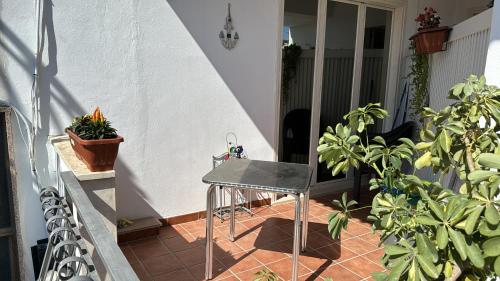 a small table on a balcony with plants at Casa Vacanza Riviera dei Saraceni in Trebisacce