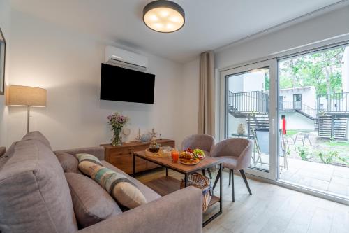 a living room with a couch and a table at Baltic Forest in Kołobrzeg