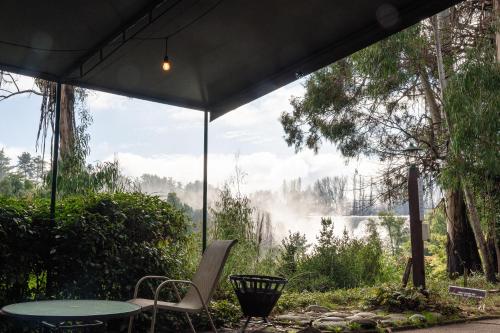 a table and chairs under a tent with a view at Hotel Salto Del Laja in Los Ángeles