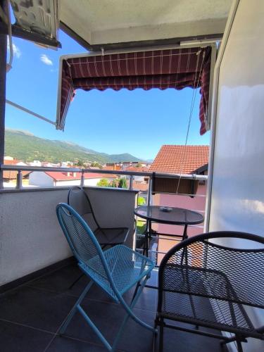 a balcony with a table and chairs and a view at Boutique Villa Aura Ohrid in Ohrid