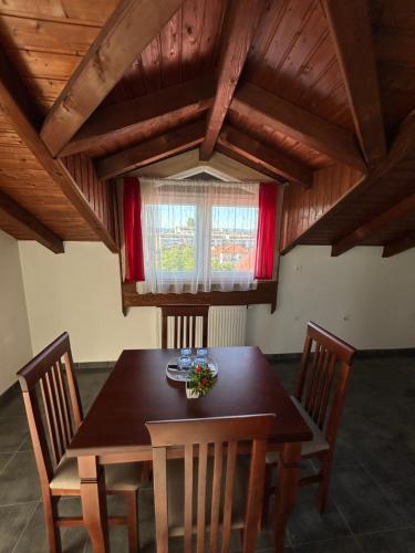 a dining room with a wooden table and chairs at Boutique Villa Aura Ohrid in Ohrid