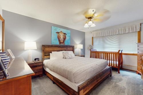 a bedroom with a bed and a desk and a window at Birch Landing #16 in Plymouth