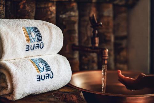 a pile of towels on a table next to a sink at Burú Nature Hotel in Leticia