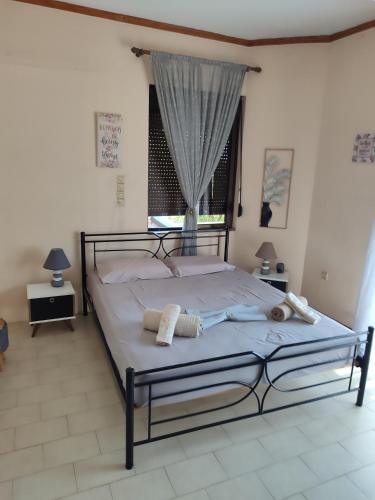 a bedroom with a bed with two towels on it at The Green Garden in AGIA VASSA in Chios