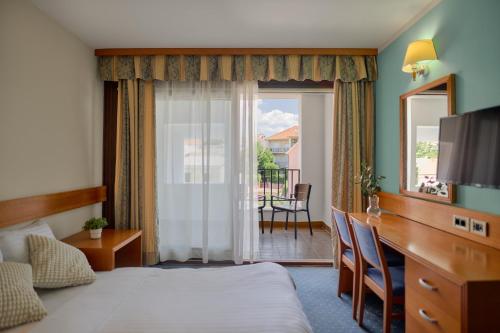 a hotel room with a bed and a sliding glass door at Hotel Selce in Selce