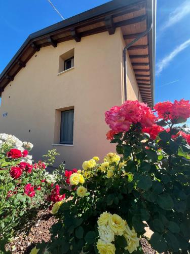 a building with a bunch of flowers in front of it at Luci di Assisi B&B Wellness in Assisi