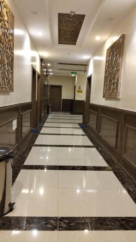 a hallway with a tile floor in a building at منتجع شاطي الاحلام in Yanbu