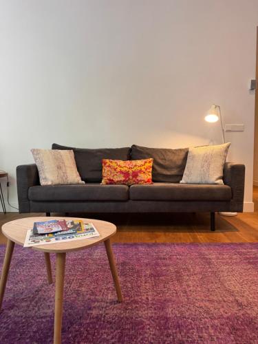 a living room with a couch and a coffee table at Barbera Guesthouse Hotel Apartments - Experience local life in the Old Centre in Haarlem