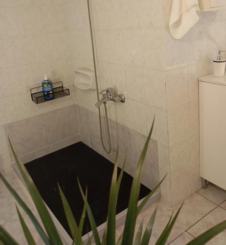 a shower with a drain in a bathroom at Sunset Dafnes beach in Patra
