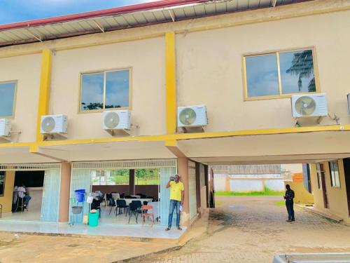 a man standing in front of a building at Royal Cockpit Hotel in Kumasi
