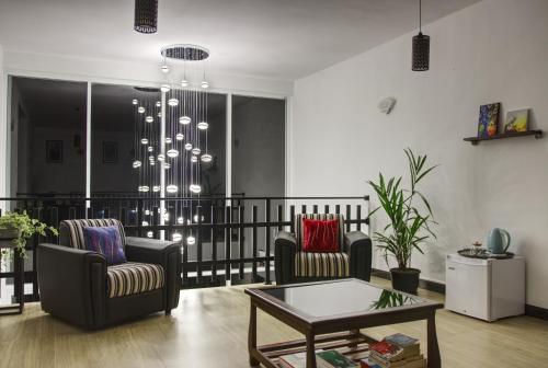 a living room with two chairs and a table at Aquahills in Kandy