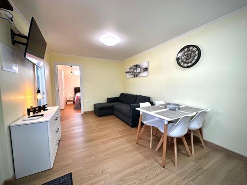 a living room with a table and a couch at One-Bedroom House close to the Beach in Armação de Pêra