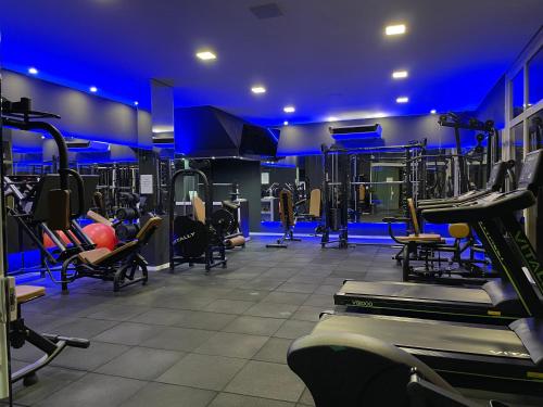 a gym with lots of tread machines in a room at Regis Hotel I in Registro