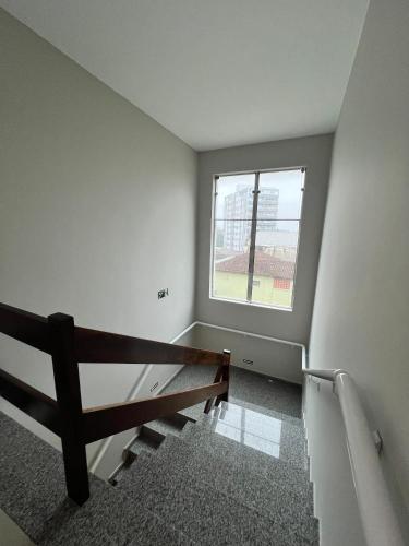 an empty room with a bench and a window at Regis Hotel I in Registro
