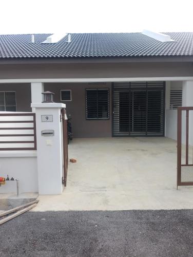a house with a white refrigerator in a driveway at Homestay Permaipura in Gua Sai