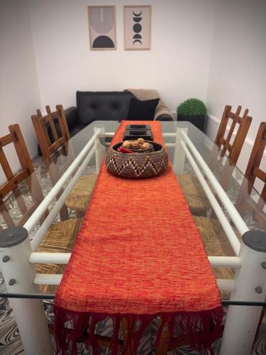 a table with an orange rug on it in a living room at Casa Berutti in La Rioja