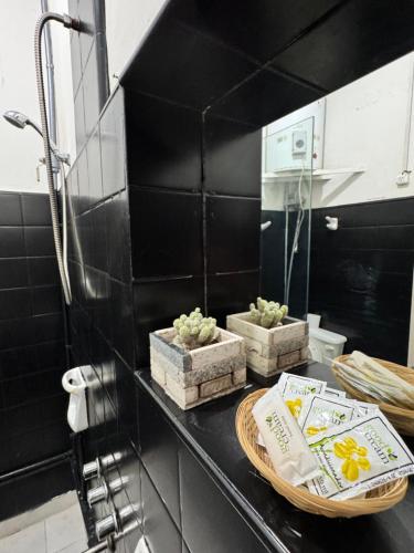 a bathroom with black walls and a counter with towels at Casa Berutti in La Rioja