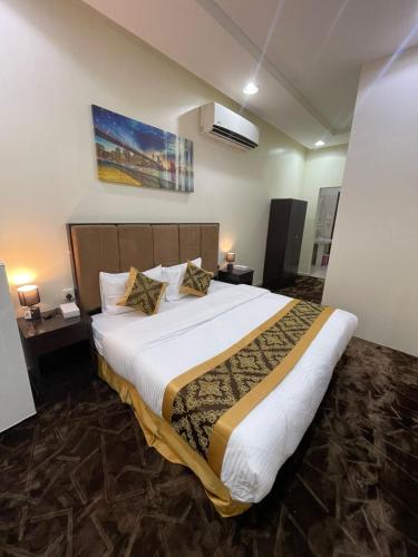 a bedroom with a large bed in a room at Quiet Rooms 1 Serviced Apartments in Riyadh