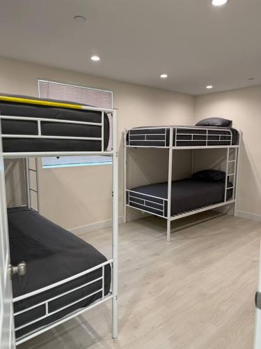 a room with three bunk beds in it at San Marino guest house in Los Angeles