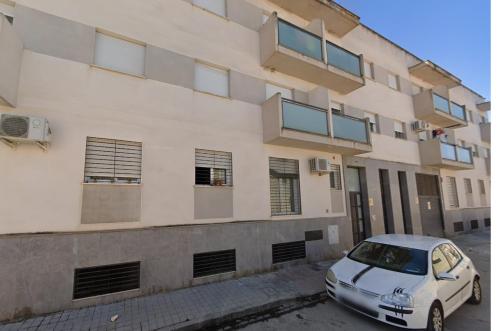 a white car parked in front of a building at Apartamento Fuente del Genil. in Fuente Vaqueros