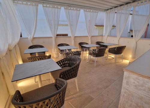 a row of tables and chairs in a restaurant at Le Cinque Lune in Vieste