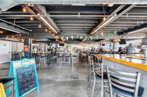 a restaurant with a bar with chairs and a counter at Aztec Ocean Resort in Seaside Heights