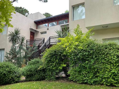 a building with bushes in front of it at Pax Costa del Este in Costa del Este