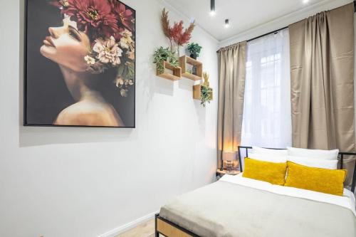 a bedroom with a bed with a painting on the wall at Central - Unique - High-End - Brand New in Budapest