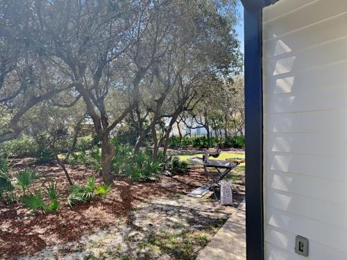 a view of a garden from the side of a house at Inlet Dunes #102 in Inlet Beach
