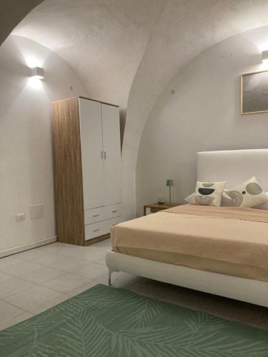 a bedroom with a bed and a cabinet in a room at F&F Room in Sassari