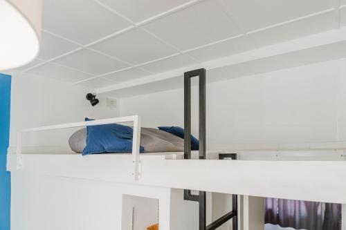 a white bunk bed with blue pillows on it at L'Estival, T2 à 5min de la gare avec WIFI in Lens